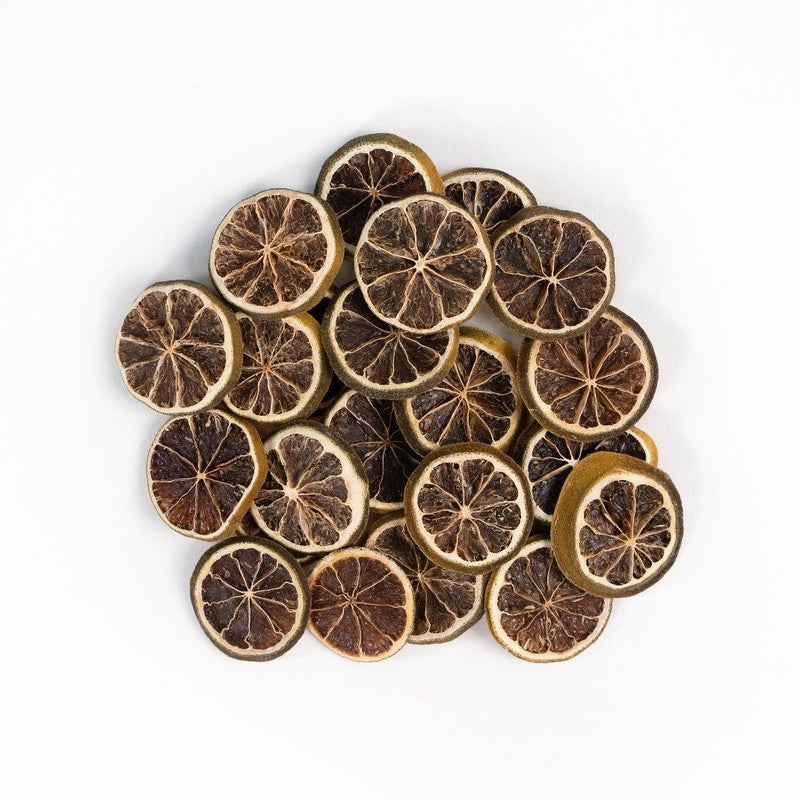 Dehydrated lime slices arranged on white background