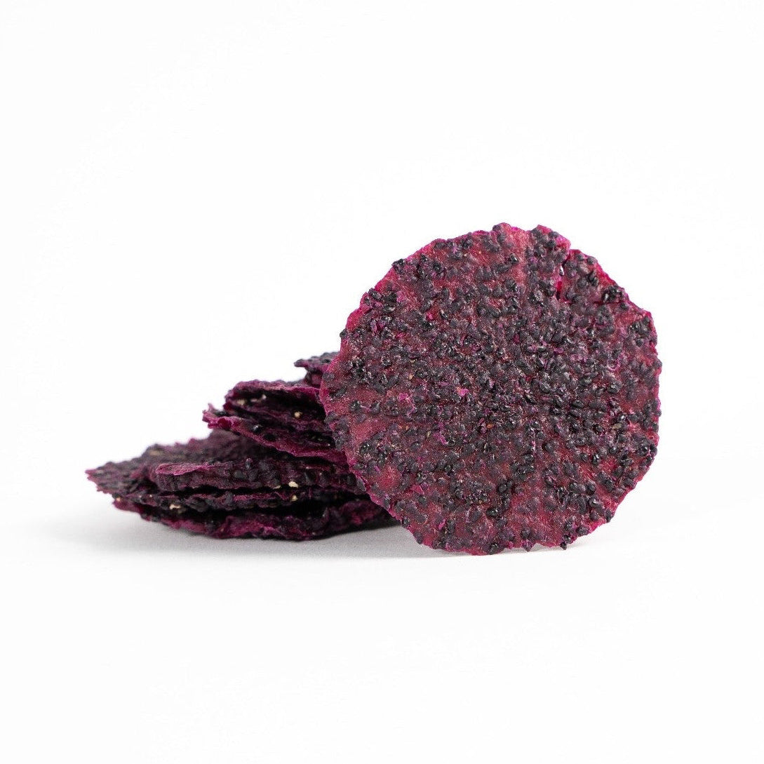 Dehydrated red dragon fruit slices on a white background